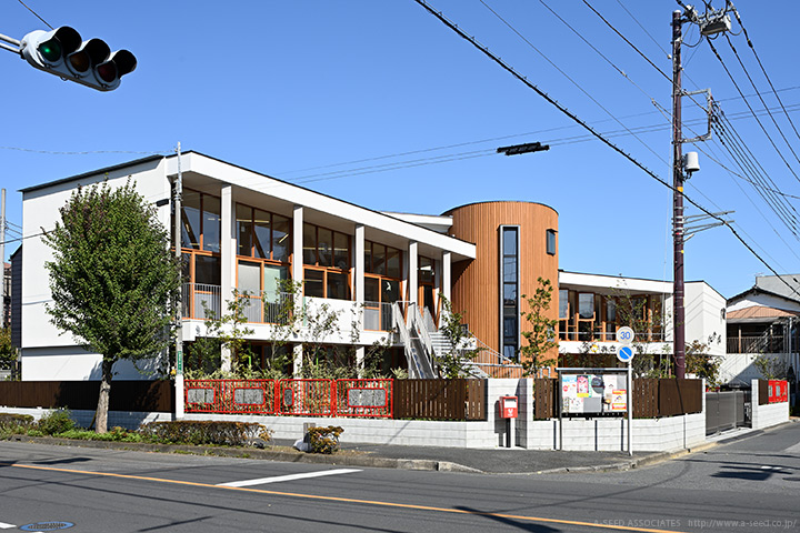 子供達がまわりで遊ぶ樹の塔の保育園